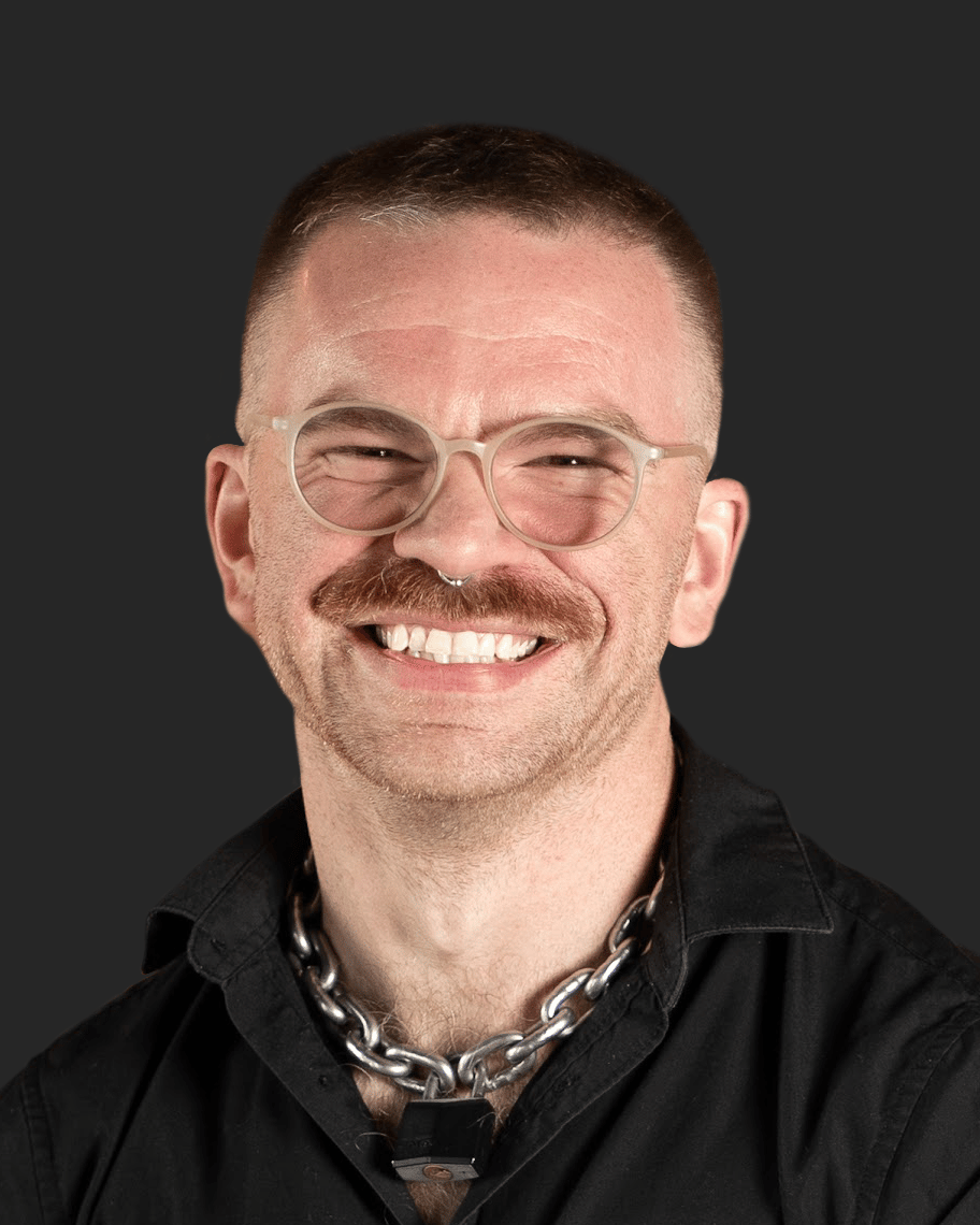 Headshot of a smiling developer with glasses and a mustache, an expert providing custom mobile app development services.