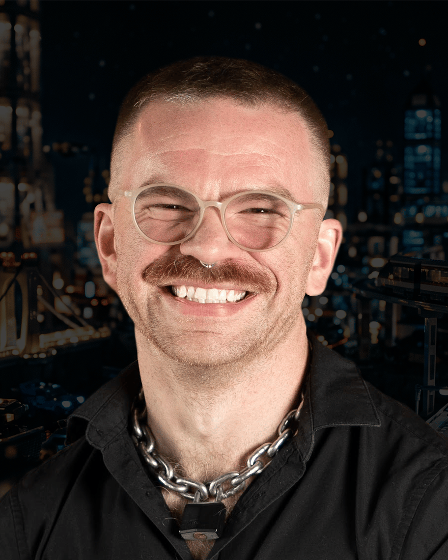 Headshot of a smiling developer with glasses and a mustache, an expert providing custom mobile app development services.