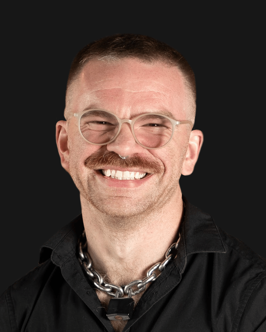 Headshot of a smiling developer with glasses and a mustache, an expert providing custom mobile app development services.