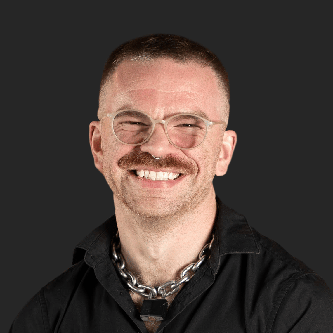 Headshot of a smiling developer with glasses and a mustache, an expert providing custom mobile app development services.